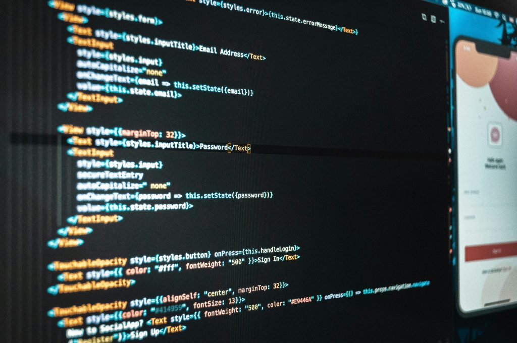 App source code on a developer's screen beside a live mobile preview